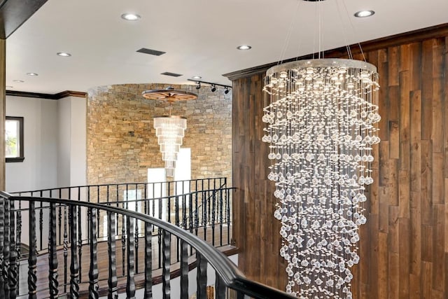 hall with a chandelier, recessed lighting, an upstairs landing, and crown molding