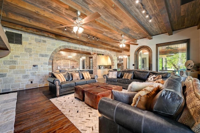living room with a ceiling fan, arched walkways, rail lighting, and wood ceiling