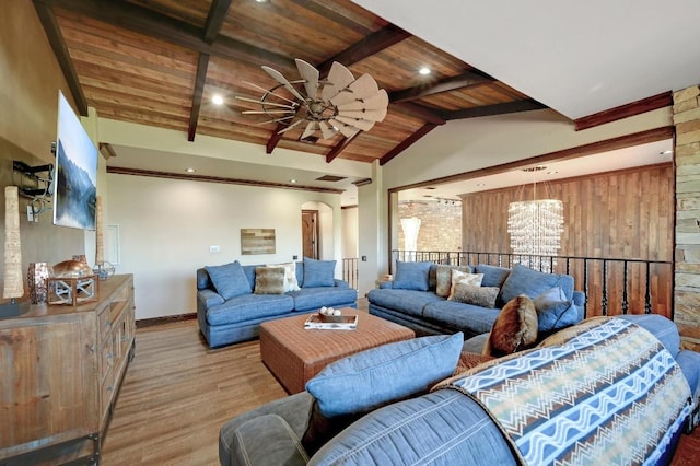 living area featuring ceiling fan with notable chandelier, wooden ceiling, wood finished floors, vaulted ceiling with beams, and baseboards