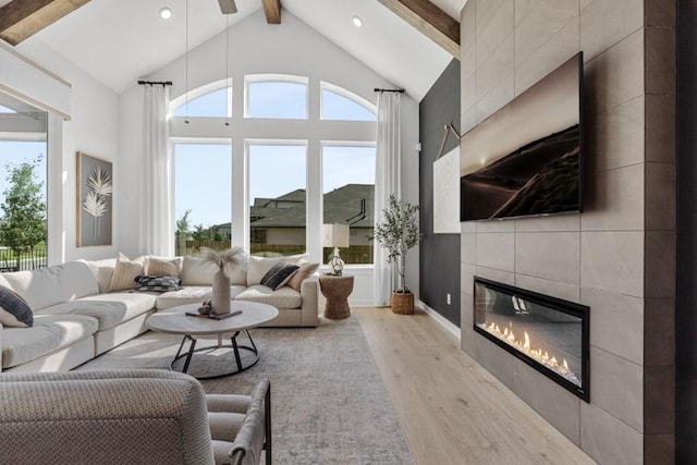 400 Veneta Ln, Georgetown, TX 78633 - living room with light wood-type flooring, a tiled fireplace, and recessed lighting