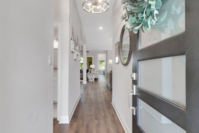 121 Monterey Oak Trl, Georgetown, TX 78628 - hall with a chandelier, baseboards, and wood finished floors