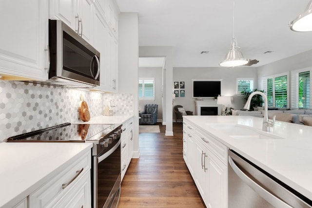 121 Monterey Oak Trl, Georgetown, TX 78628 - kitchen with light wood-style flooring, stainless steel appliances, a wealth of natural light, a sink, and open floor plan