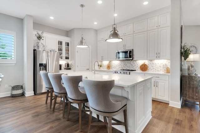 121 Monterey Oak Trl, Georgetown, TX 78628 - kitchen with appliances with stainless steel finishes, white cabinetry, a kitchen island with sink, and light wood-style flooring