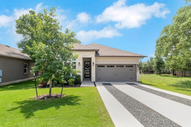 121 Monterey Oak Trl, Georgetown, TX 78628 - view of front of property featuring a front yard, concrete driveway, stone siding, and an attached garage