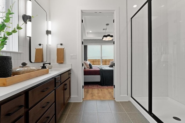 105 Sandrock Trl, Georgetown, TX 78633 - bathroom featuring ensuite bath, vanity, a stall shower, tile patterned floors, and recessed lighting