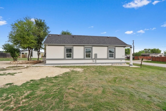 view of front of home with a front yard, fence, and a patio
