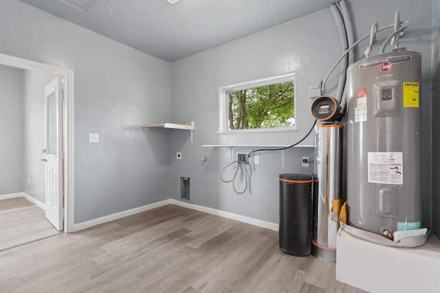 washroom featuring laundry area, water heater, wood finished floors, washer hookup, and hookup for an electric dryer