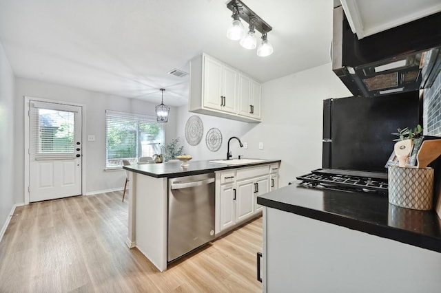 3309 Clawson Rd, Austin, TX 78704 - kitchen featuring dishwasher, a sink, light wood-style flooring, dark countertops, and white cabinets