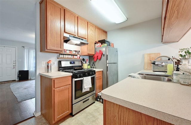 3309 Clawson Rd, Austin, TX 78704 - kitchen featuring stainless steel appliances, under cabinet range hood, a sink, and light countertops