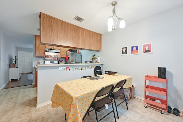 dining room featuring baseboards, visible vents, and light tile patterned flooring