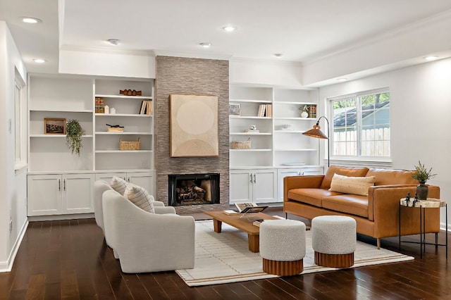 living room featuring recessed lighting, dark wood-type flooring, ornamental molding, and built in shelves
