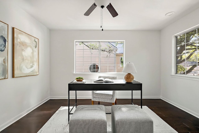 office area with dark wood-style floors, baseboards, and a ceiling fan