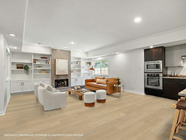 1702 Newning Ave Unit B, Austin, TX 78704 - living area featuring light wood-style floors, a large fireplace, baseboards, recessed lighting, and crown molding