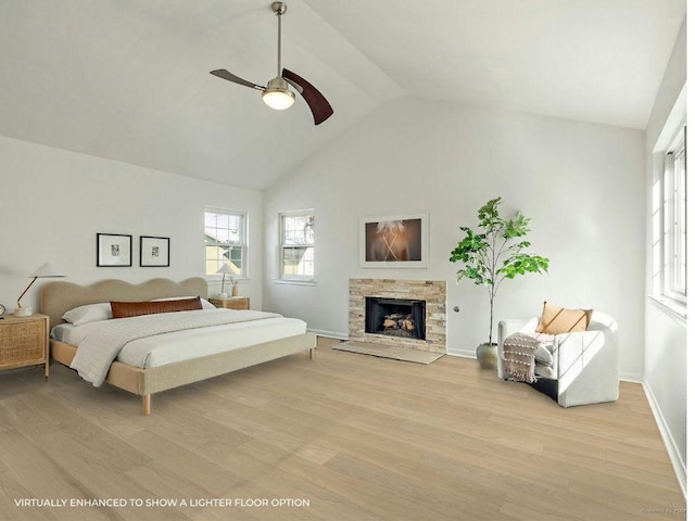 1702 Newning Ave Unit B, Austin, TX 78704 - bedroom featuring light wood-type flooring, a stone fireplace, baseboards, ceiling fan, and high vaulted ceiling