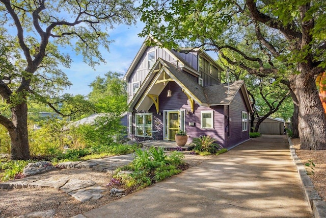 1008 W Monroe St W, Austin, TX 78704 - view of front of house with an outbuilding, concrete driveway, and board and batten siding