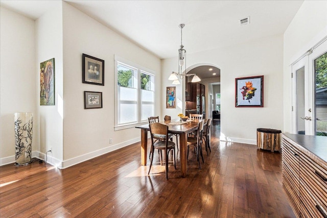 1008 W Monroe St W, Austin, TX 78704 - dining room with arched walkways, dark wood finished floors, and baseboards