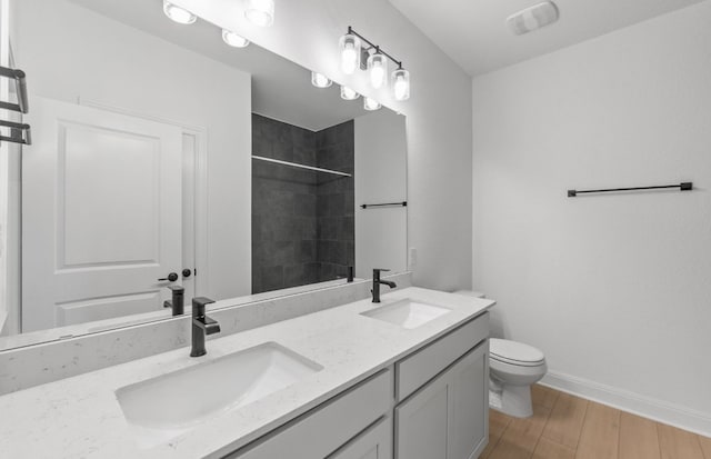 6517 Apache Plum Ln, Spicewood, TX 78669 - full bathroom with a tile shower, double vanity, and wood finished floors
