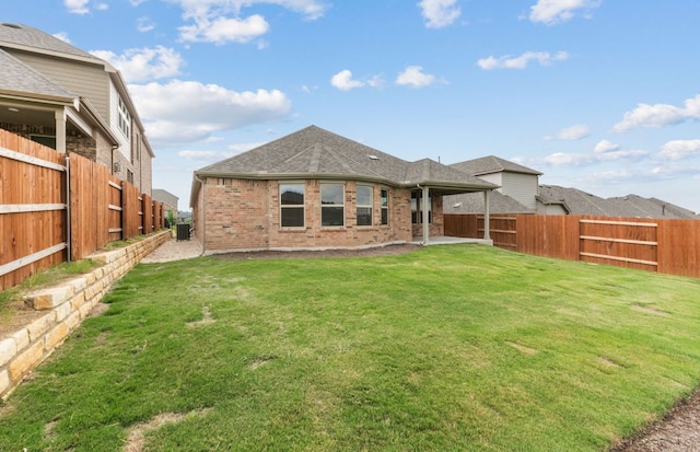 6517 Apache Plum Ln, Spicewood, TX 78669 - back of property featuring a fenced backyard, brick siding, and a shingled roof