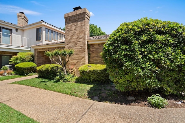 1101 Lakeway Dr Unit D, Lakeway, TX 78734 - view of side of home featuring a chimney and brick siding