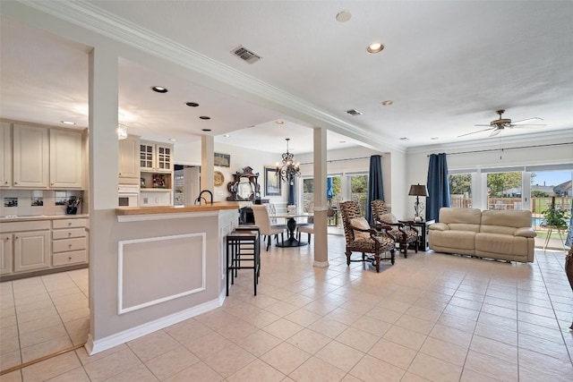 1101 Lakeway Dr Unit D, Lakeway, TX 78734 - living area with crown molding, light tile patterned floors, a ceiling fan, recessed lighting, and a chandelier