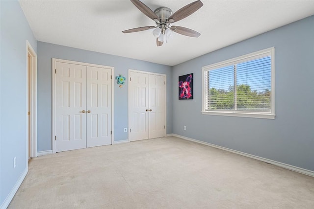 1101 Lakeway Dr Unit D, Lakeway, TX 78734 - unfurnished bedroom with two closets, carpet floors, and ceiling fan