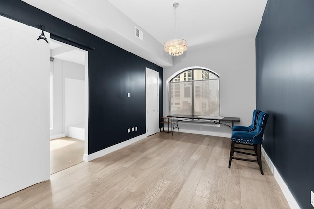 507 Sabine St Unit 505, Austin, TX 78701 - unfurnished room featuring wood finished floors and a chandelier