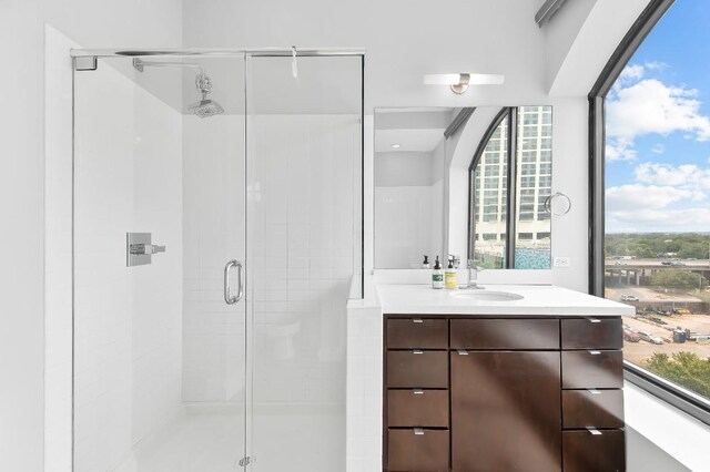 507 Sabine St Unit 505, Austin, TX 78701 - bathroom with a stall shower, vanity, and healthy amount of natural light