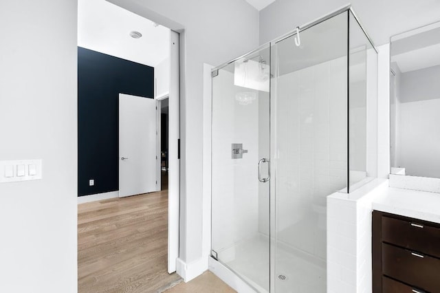 507 Sabine St Unit 505, Austin, TX 78701 - full bath featuring wood finished floors, a shower stall, and vanity
