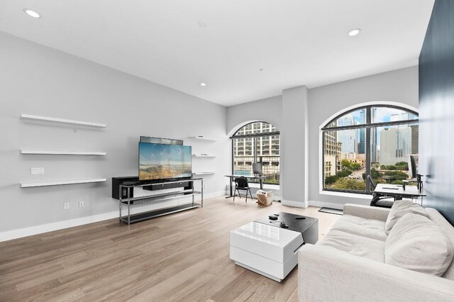 507 Sabine St Unit 505, Austin, TX 78701 - living area featuring wood finished floors, recessed lighting, and a desk