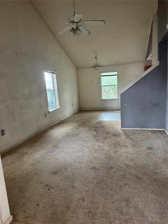 unfurnished room featuring carpet floors, ceiling fan, and high vaulted ceiling