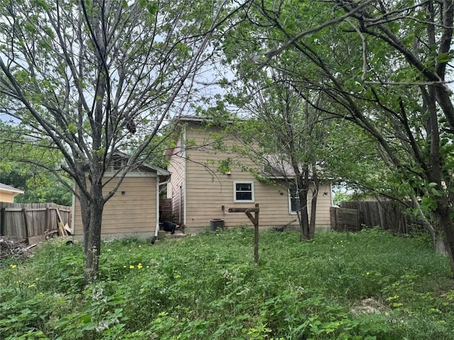 rear view of property featuring fence