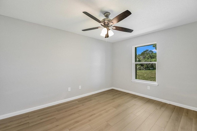unfurnished room with light wood-style floors, baseboards, and a ceiling fan