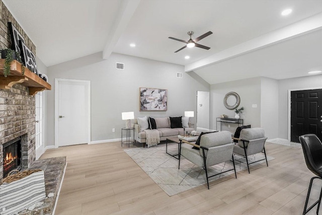 living room with light wood finished floors, visible vents, vaulted ceiling with beams, and a ceiling fan