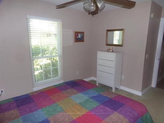 bedroom with baseboards and a ceiling fan