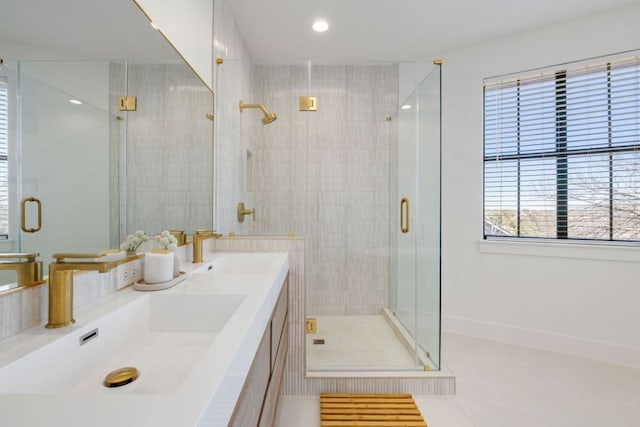 full bath featuring a shower stall, tile patterned flooring, and a sink