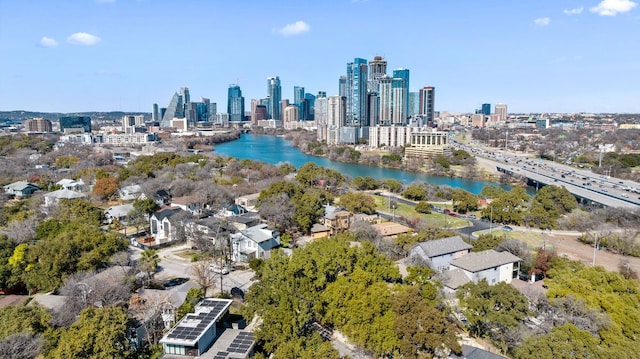 birds eye view of property with a water view and a city view