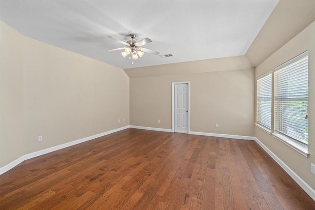 spare room with dark wood-style flooring, baseboards, a ceiling fan, and lofted ceiling