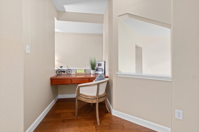 office space with wood finished floors and baseboards