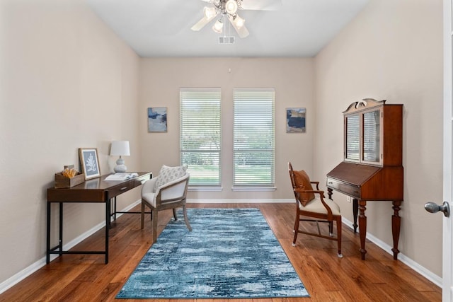 home office featuring baseboards, wood finished floors, and ceiling fan