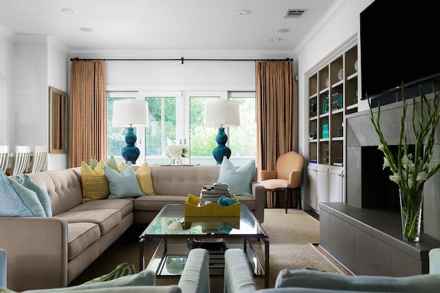 living area with ornamental molding, visible vents, and carpet flooring