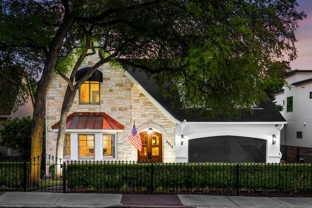 view of front facade with a fenced front yard and stone siding