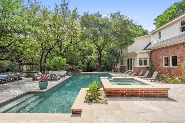 2601 Buckminister Ct, Austin, TX 78746 - view of swimming pool featuring a patio, a pool with connected hot tub, french doors, and an outdoor living space