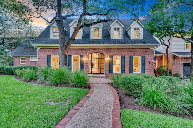 2601 Buckminister Ct, Austin, TX 78746 - new england style home with brick siding, a shingled roof, and a front yard