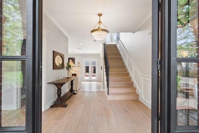 2601 Buckminister Ct, Austin, TX 78746 - entrance foyer with crown molding, stairway, and light wood-type flooring
