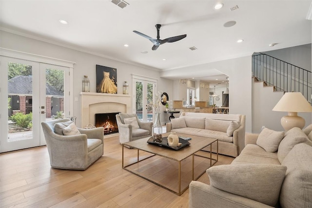 2601 Buckminister Ct, Austin, TX 78746 - living room featuring ceiling fan, ornamental molding, light wood finished floors, a lit fireplace, and recessed lighting
