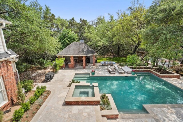 2601 Buckminister Ct, Austin, TX 78746 - view of pool featuring a patio, exterior bar, a storage structure, a pool with connected hot tub, and an outdoor structure