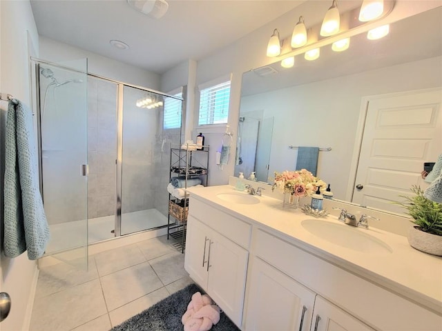 1765 Yaupon Grove Ln, Leander, TX 78641 - bathroom with tile patterned floors, a stall shower, and double vanity
