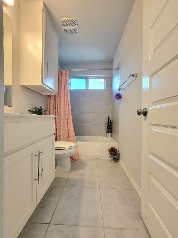1765 Yaupon Grove Ln, Leander, TX 78641 - bathroom featuring tile patterned flooring, vanity, and shower / bath combination with curtain