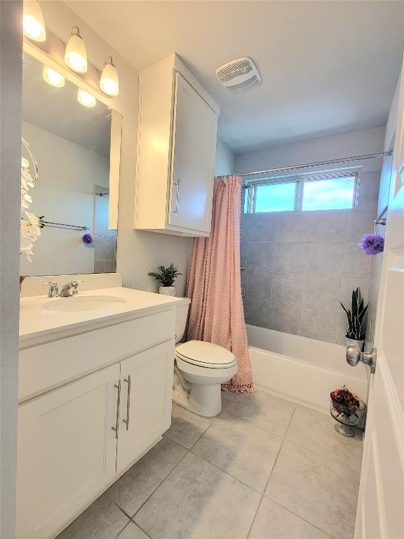 1765 Yaupon Grove Ln, Leander, TX 78641 - bathroom featuring tile patterned flooring, vanity, and shower / tub combo with curtain