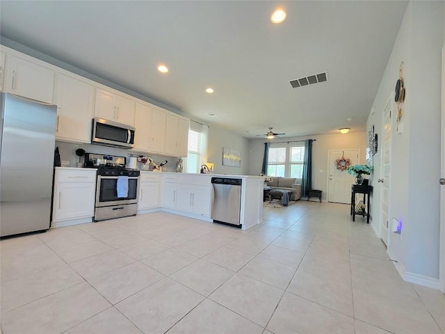 1765 Yaupon Grove Ln, Leander, TX 78641 - kitchen with appliances with stainless steel finishes, a peninsula, open floor plan, a ceiling fan, and recessed lighting